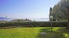 Spacious ground-floor three-room apartment with private garden and lake view in Gardone Riviera for sale